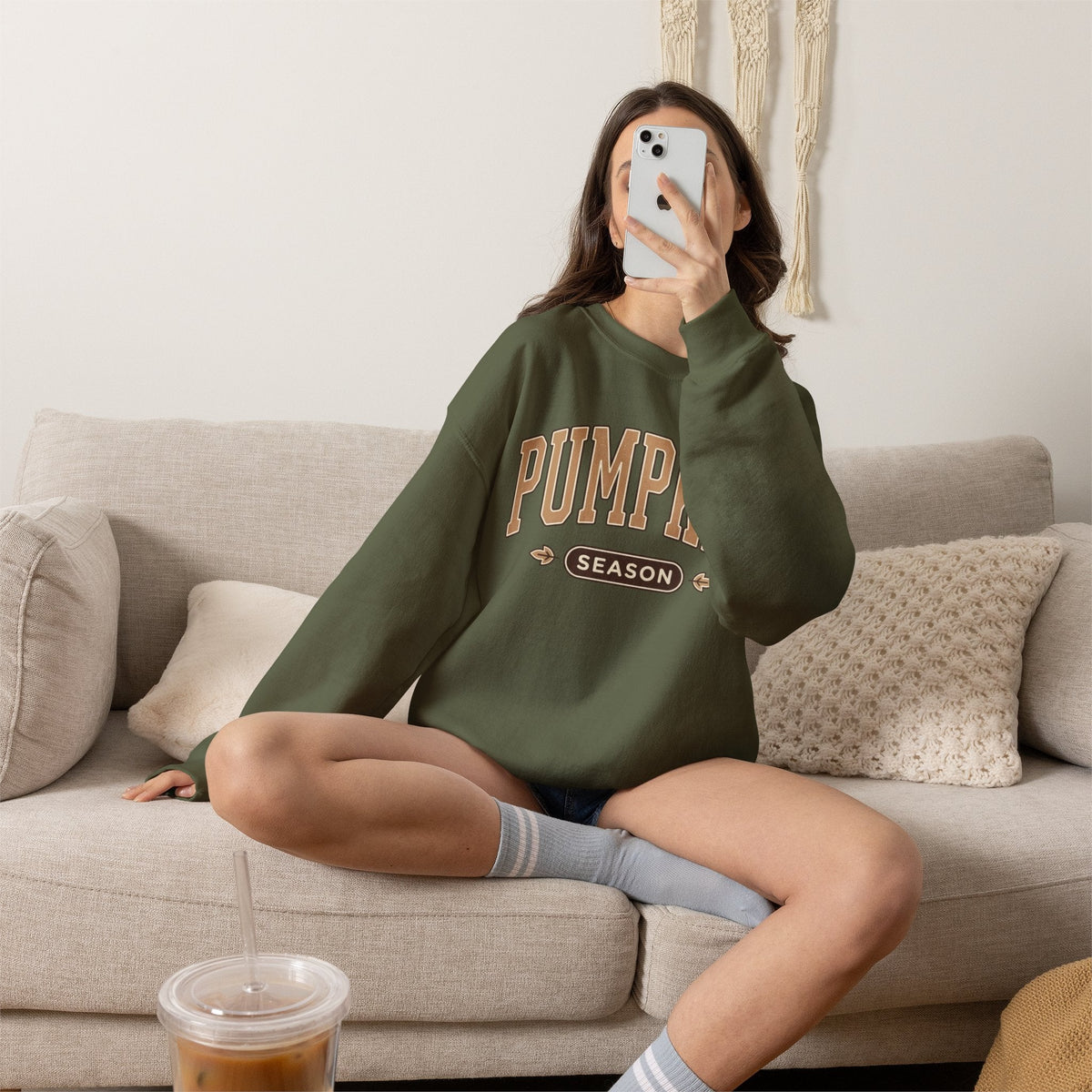 Wicked Thread Society olive green crewneck sweatshirt with vintage-inspired Pumpkin Season graphic on a cozy sofa