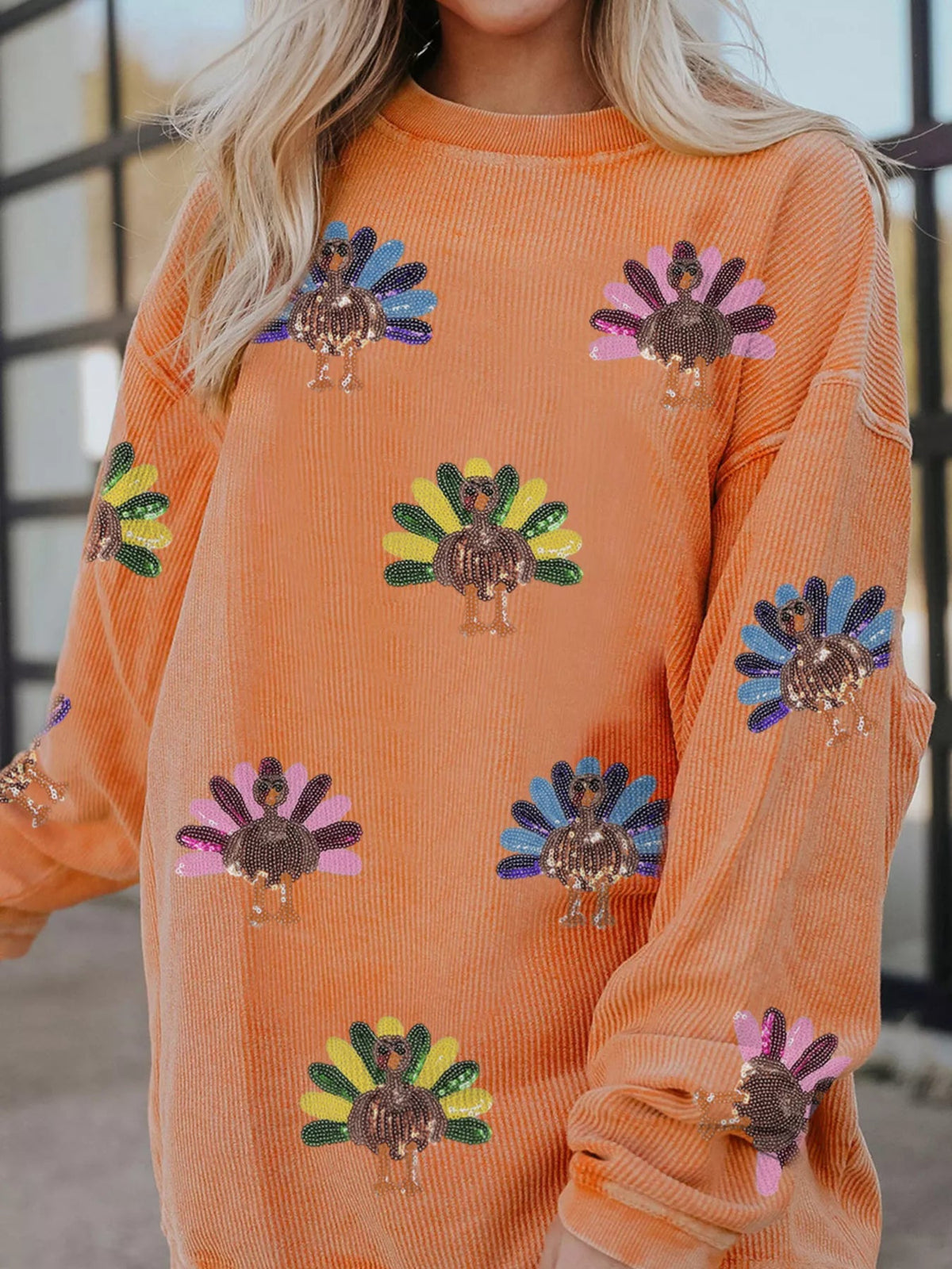 Wicked Thread Society orange corded crewneck sweatshirt featuring a playful turkey graphic with colorful sequins.