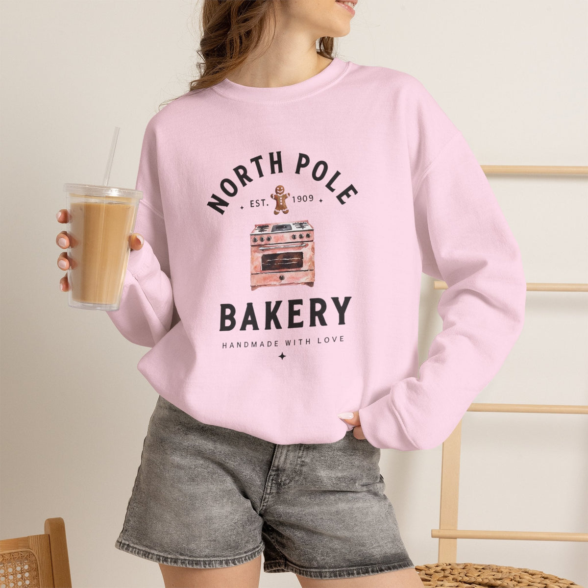Wicked Thread Society light pink crewneck sweatshirt with a North Pole Bakery oven and gingerbread man graphic