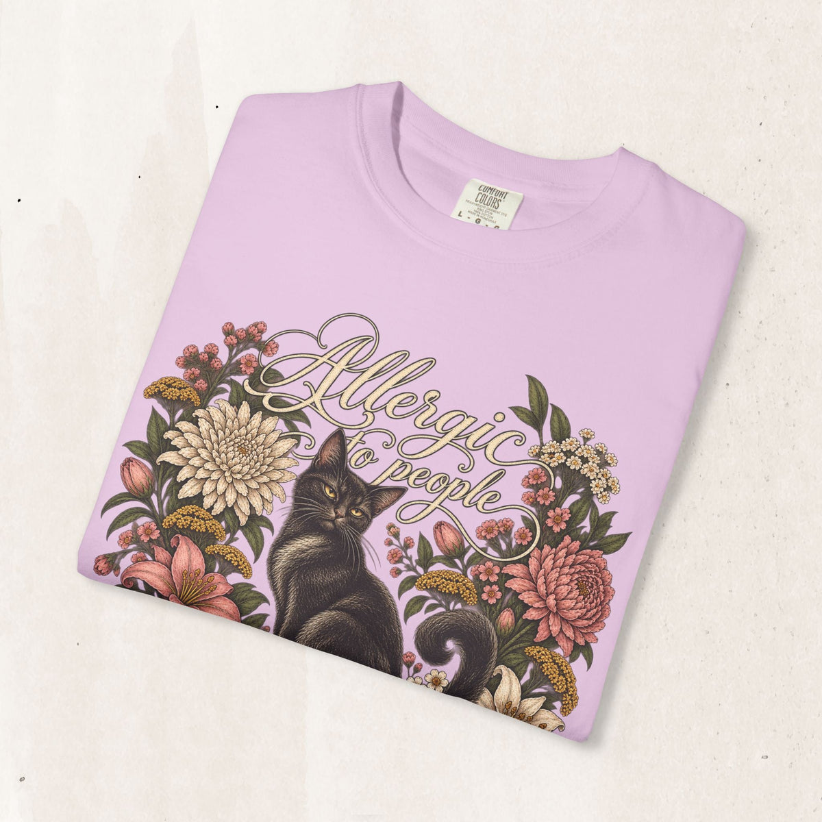 Wicked Thread Society light pink graphic t-shirt featuring a black cat illustration and floral wreath design.