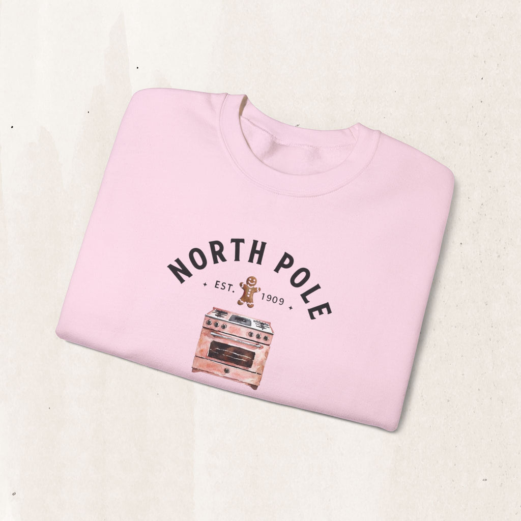Wicked Thread Society light pink crewneck sweatshirt with a North Pole Bakery gingerbread and oven graphic print.