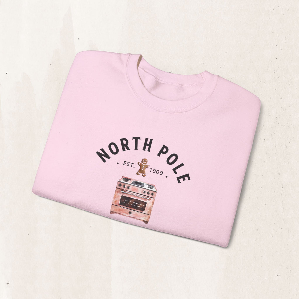 Wicked Thread Society light pink crewneck sweatshirt with a North Pole Bakery gingerbread and oven graphic print.