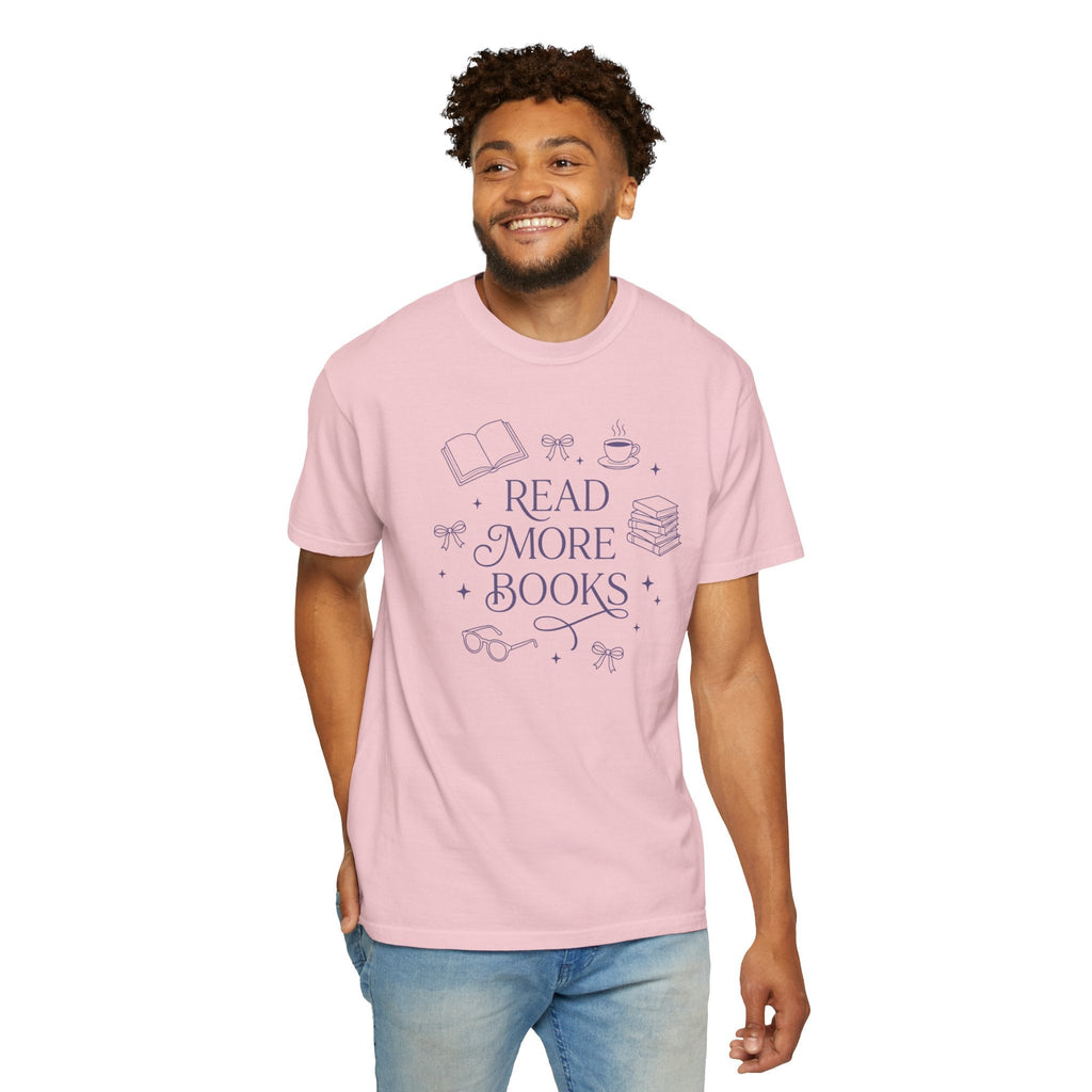 Wicked Thread Society light pink graphic tee with Read More Books illustration worn by a smiling man in blue jeans.
