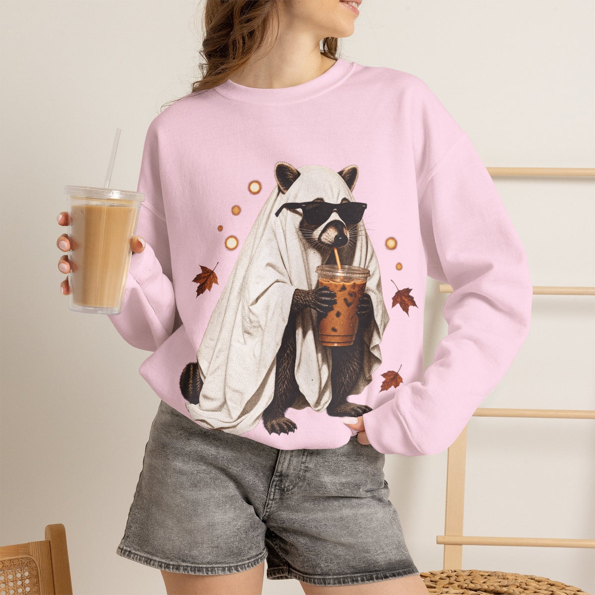 Wicked Thread Society light pink crewneck sweatshirt featuring a raccoon in a ghost costume drinking boba tea