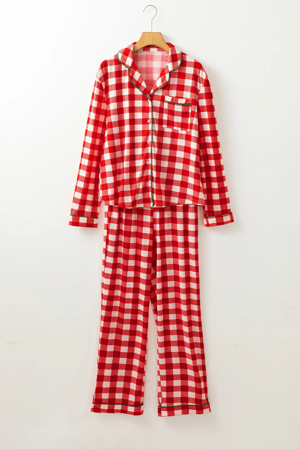 Wicked Thread Society red and white plaid long sleeve button-down pajama set with green trim on a wooden hanger