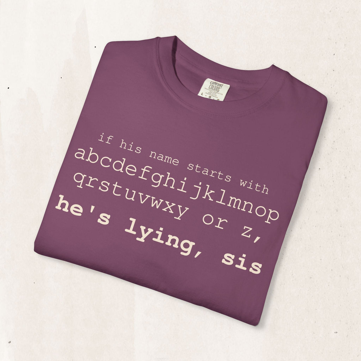 He's Lying, Sis T-shirt | Typographic alphabet humor tee Printify