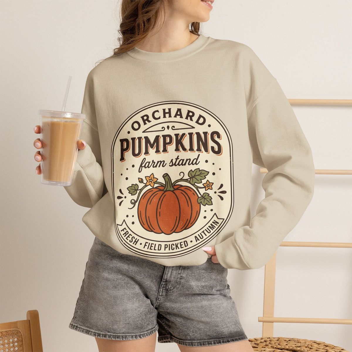 Wicked Thread Society beige crewneck sweatshirt with vintage pumpkin farmstand graphic, worn with grey denim shorts.