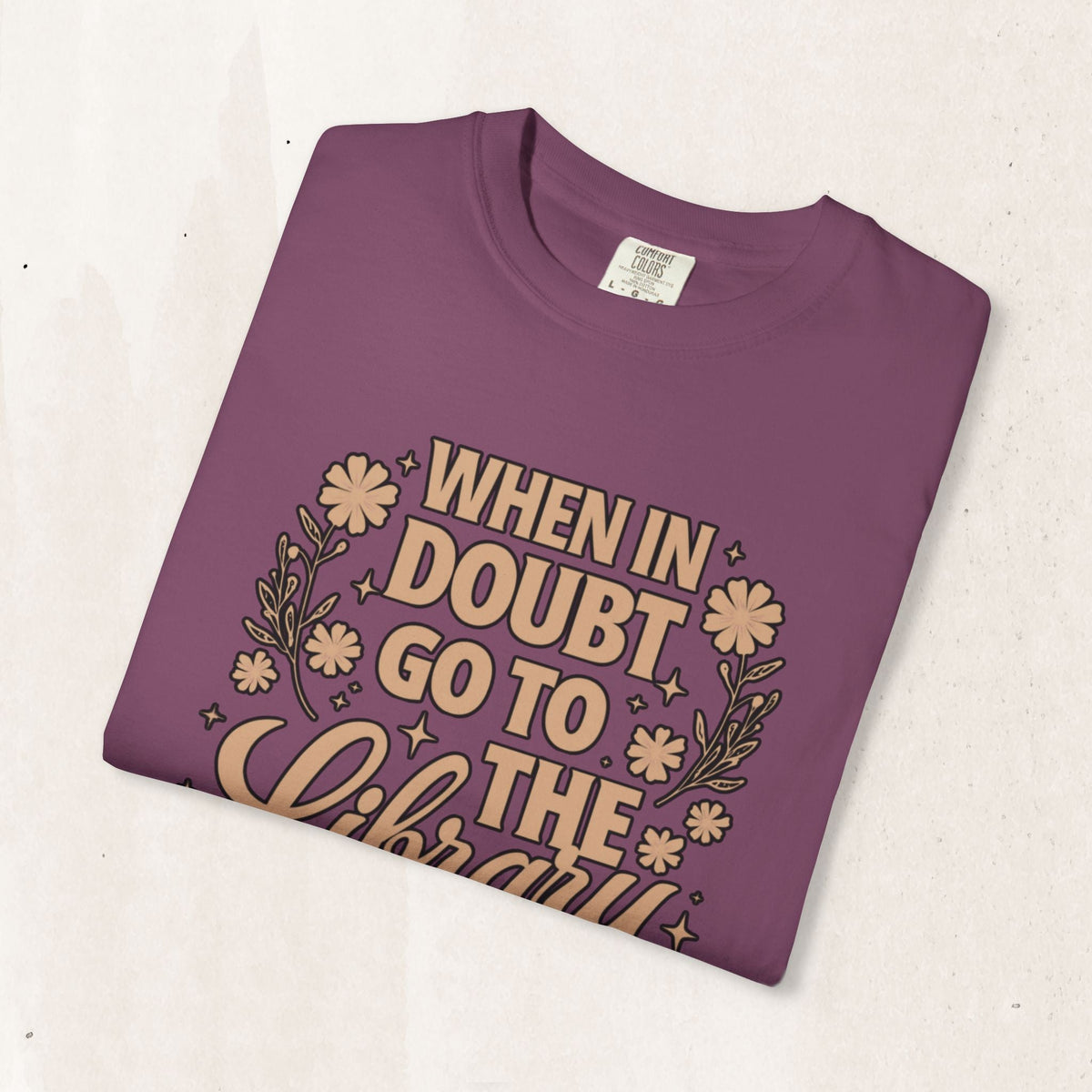 Wicked Thread Society purple garment-dyed cotton graphic tee with When in Doubt Go to the Library floral print
