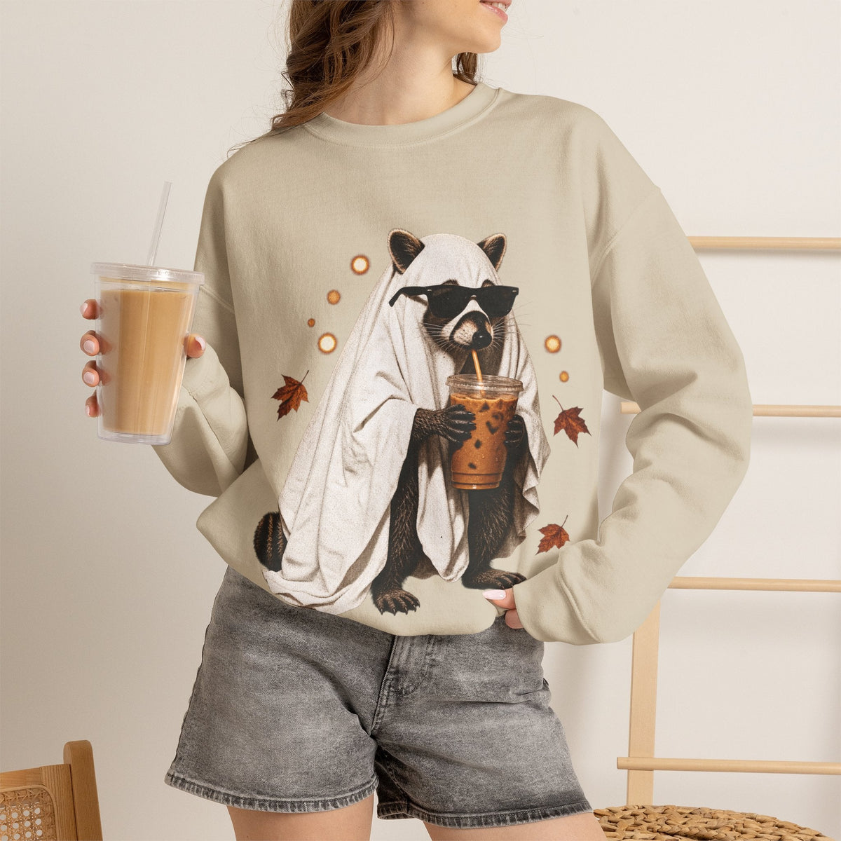 Wicked Thread Society beige crewneck sweatshirt featuring a raccoon in a ghost costume drinking boba tea