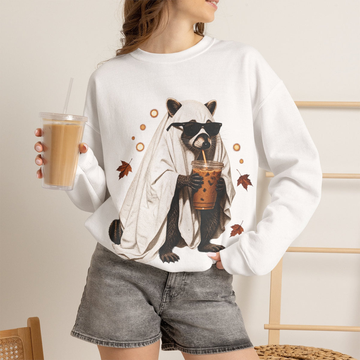 Wicked Thread Society white crewneck sweatshirt featuring a raccoon in a ghost costume drinking boba tea