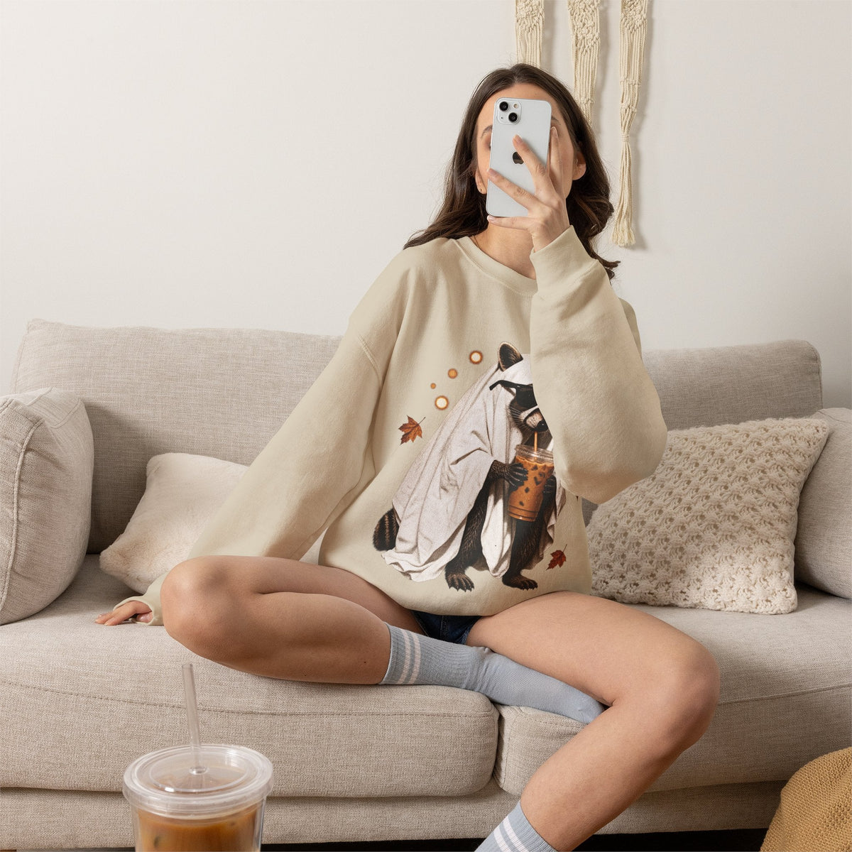Wicked Thread Society beige crewneck sweatshirt featuring a cute raccoon in a ghost costume holding a boba tea.