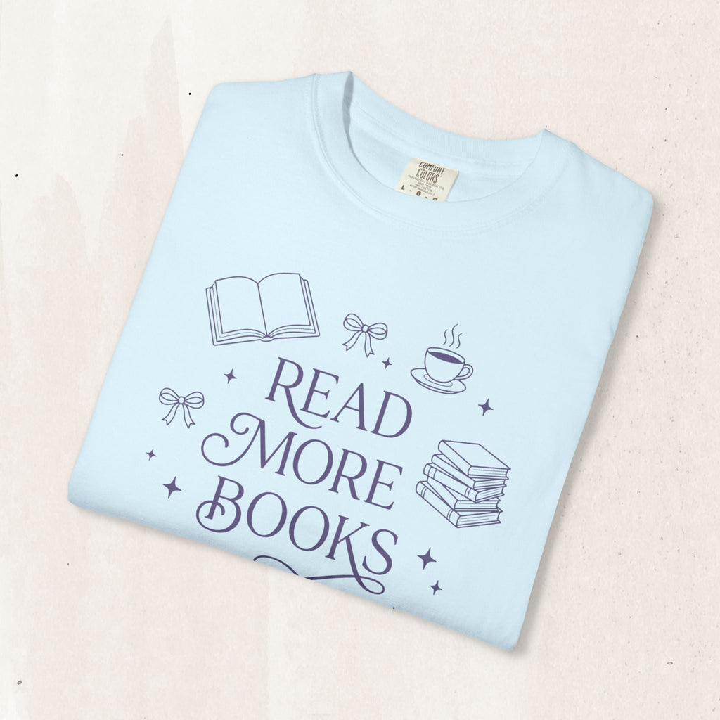 Wicked Thread Society light blue garment-dyed cotton t-shirt featuring a Read More Books graphic with book icons.