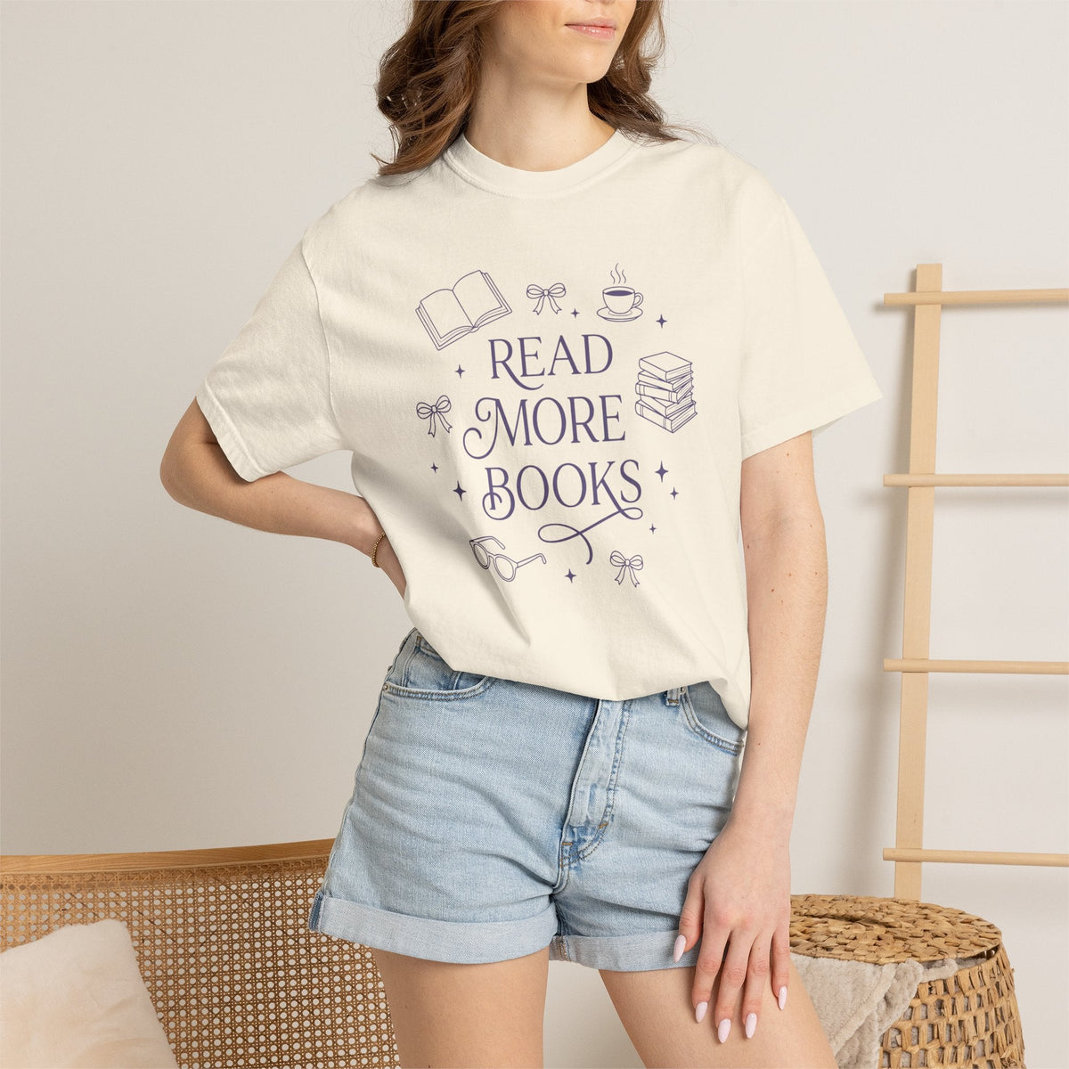 Wicked Thread Society cream cotton graphic tee with Read More Books illustration worn by a woman with denim shorts.