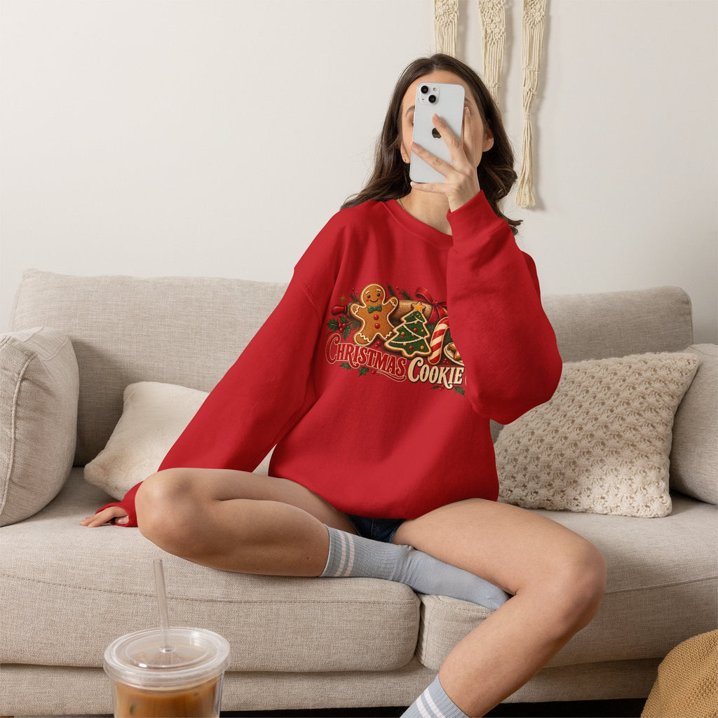 Wicked Thread Society red Christmas Cookie Club crewneck sweatshirt with gingerbread and candy cane graphic on couch