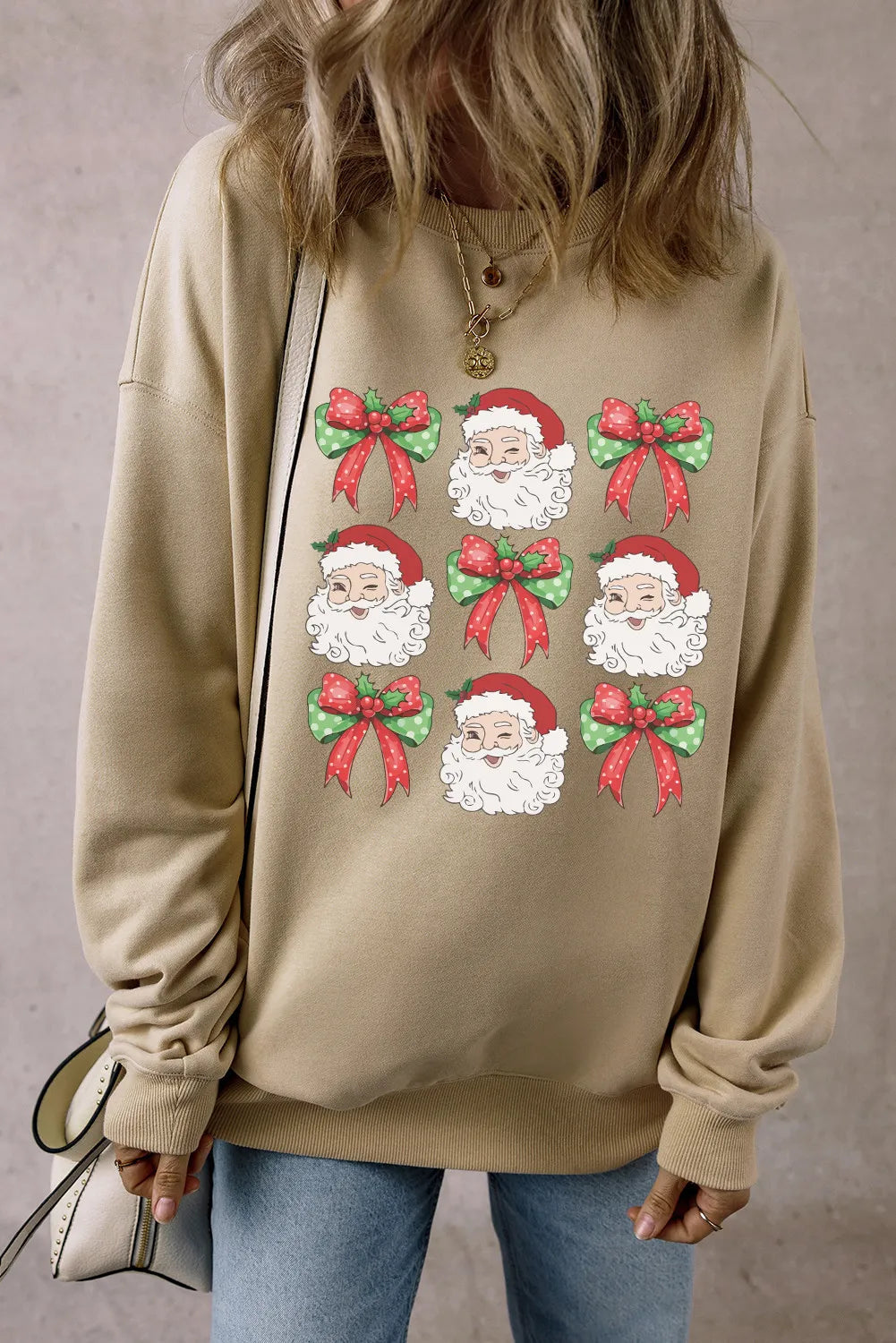 Wicked Thread Society beige long sleeve sweatshirt featuring a repeating Santa Claus and festive bow graphic print