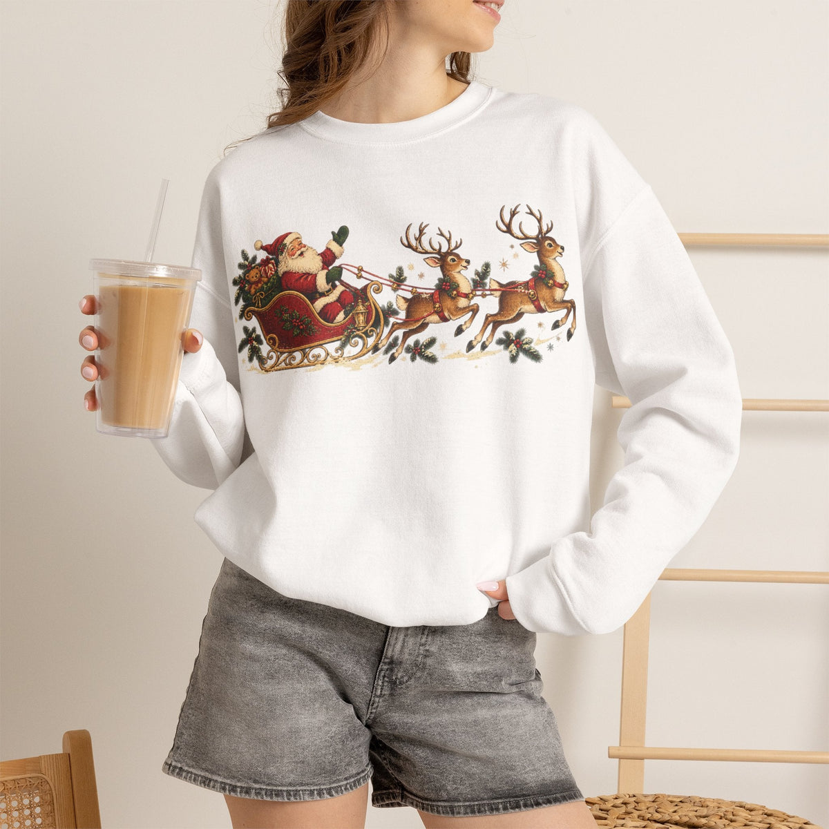 Wicked Thread Society white crewneck sweatshirt featuring a vintage Santa sleigh and reindeer print on a woman