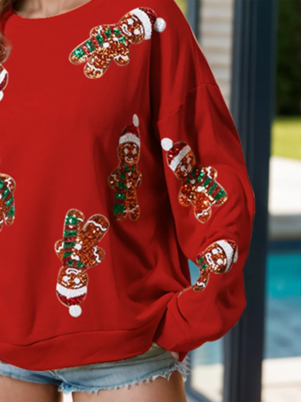 Wicked Thread Society red long sleeve sweatshirt featuring festive sequin gingerbread man patterns for the holidays.