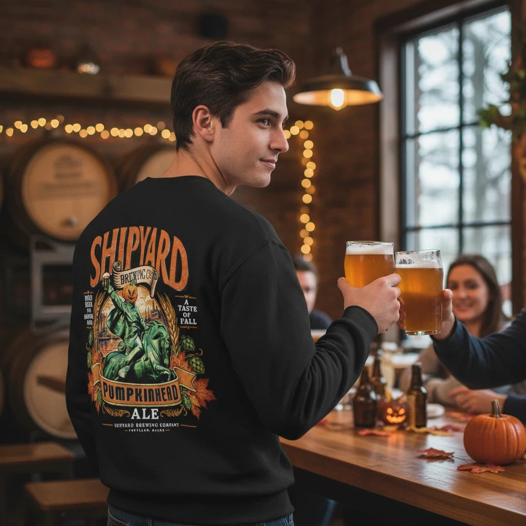 Wicked Thread Society black crewneck sweatshirt with Shipyard Pumpkinhead Ale back graphic in a brewery setting