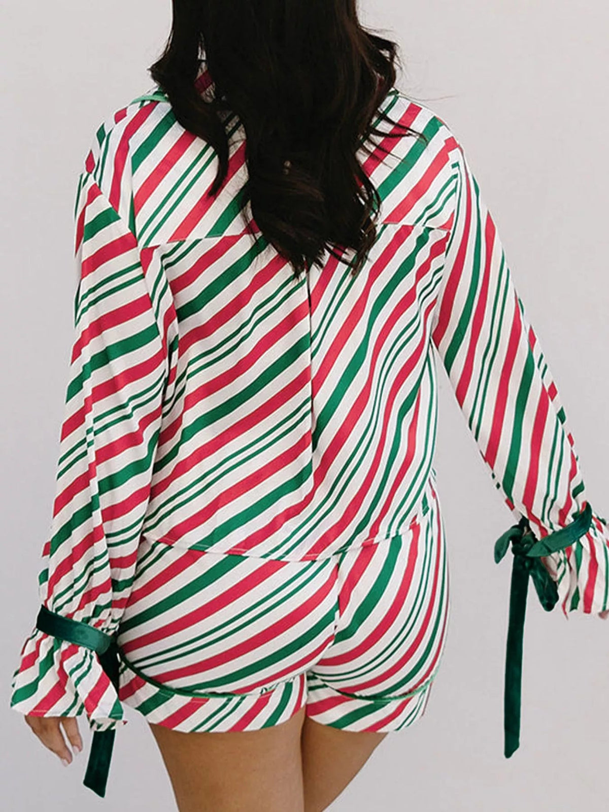 Wicked Thread Society two-piece Christmas pajama set with red, white, and green diagonal stripes and velvet ribbons.
