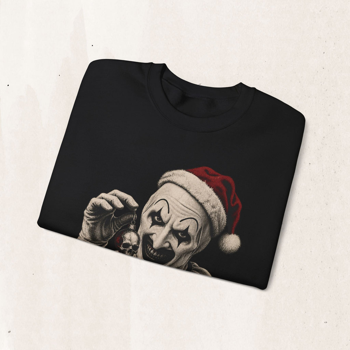Wicked Thread Society black crewneck sweatshirt featuring Art the Clown in a Santa hat holding a skull ornament.