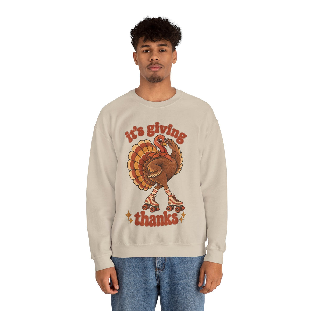 A man wearing a Wicked Thread Society beige crewneck sweatshirt featuring a retro roller-skating turkey graphic.