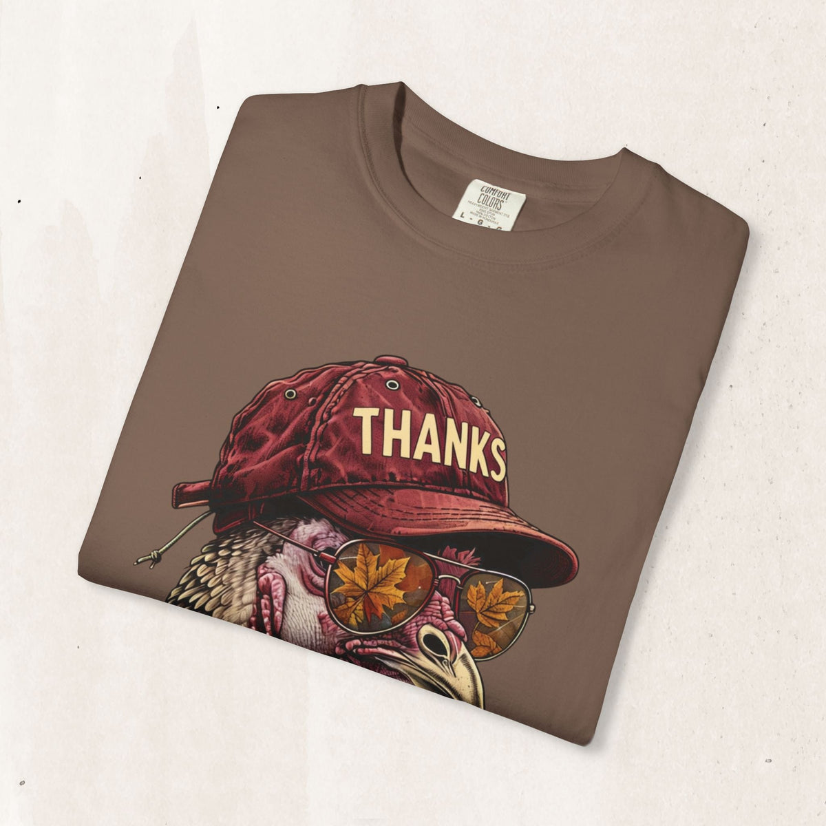Wicked Thread Society brown Thanksgiving t-shirt featuring a turkey wearing a red baseball cap and autumn sunglasses.