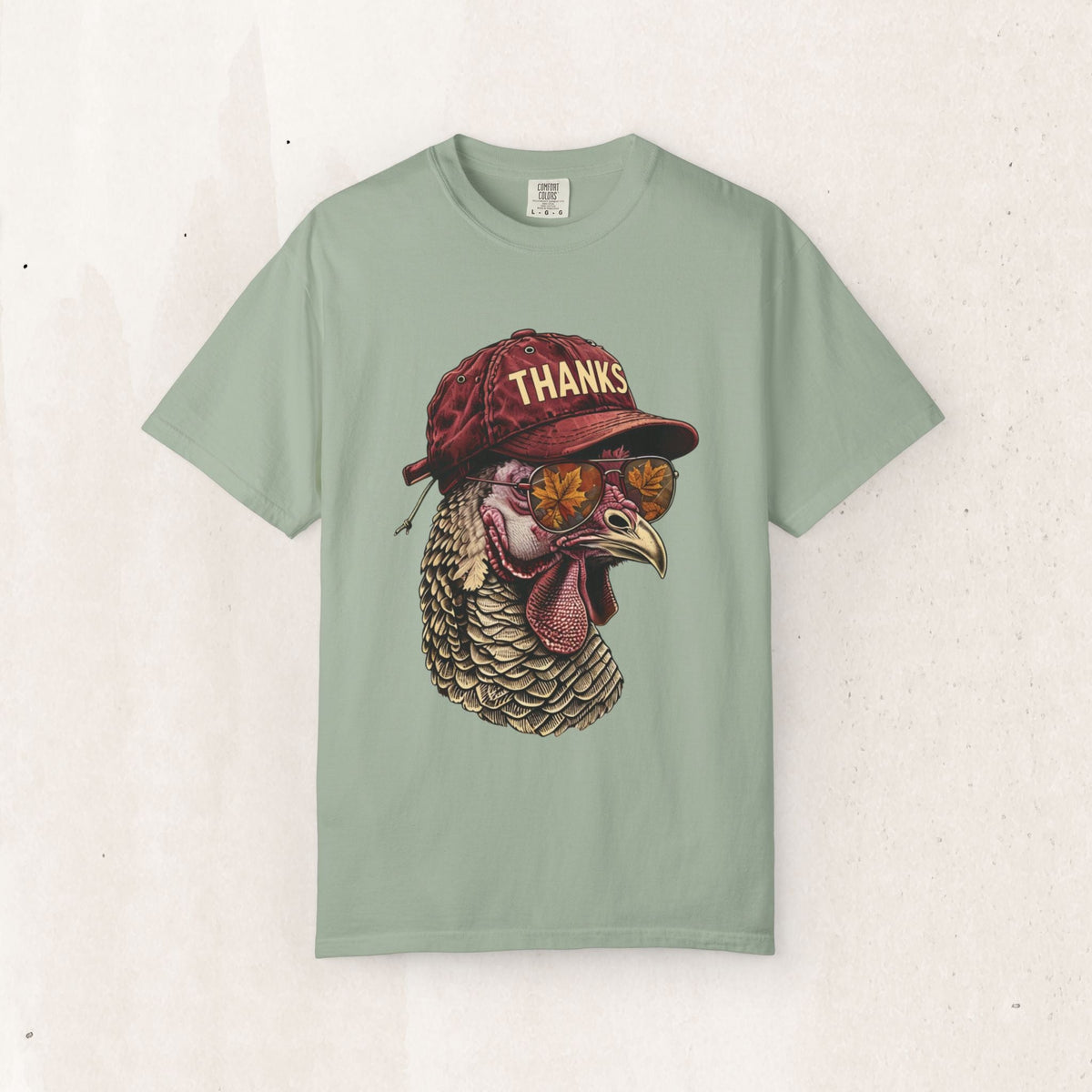 Wicked Thread Society sage green Thanksgiving t-shirt featuring a cool turkey wearing a red cap and sunglasses.