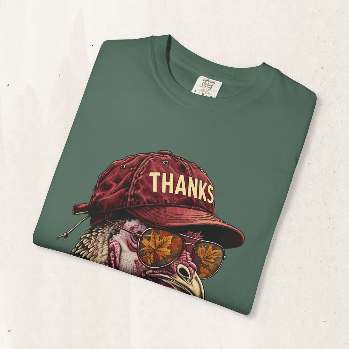 Wicked Thread Society green t-shirt featuring a turkey wearing a red baseball cap and sunglasses with autumn leaves.