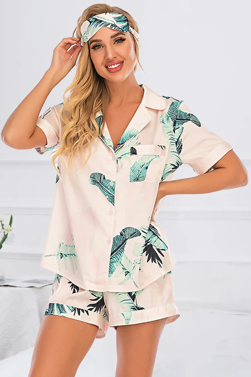 Wicked Thread Society two-piece lounge set with a pink and green tropical leaf print, button-up top, and shorts.