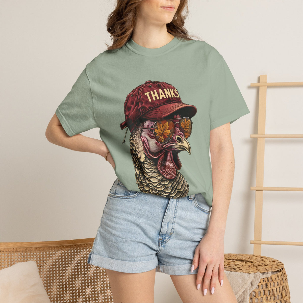 Wicked Thread Society sage green t-shirt featuring a graphic of a turkey wearing a red baseball cap and sunglasses.