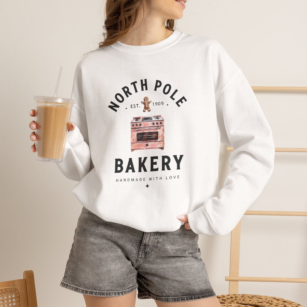 Wicked Thread Society white crewneck sweatshirt featuring a North Pole Bakery oven and gingerbread man graphic.