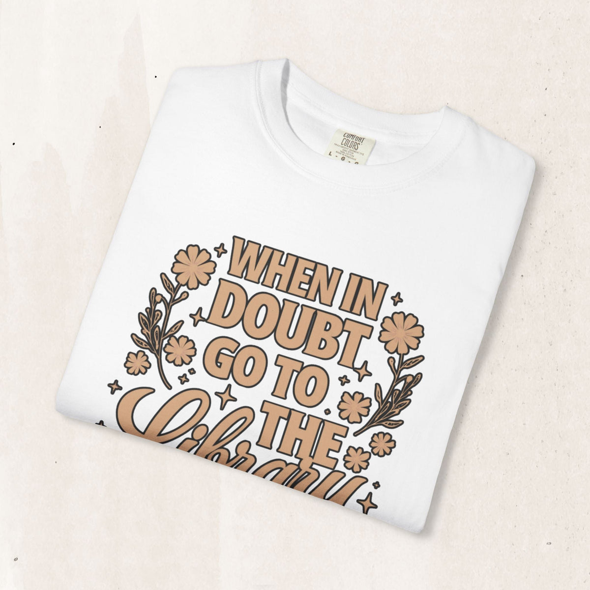 Wicked Thread Society white cotton graphic tee with When in Doubt Go to the Library text and floral illustrations.