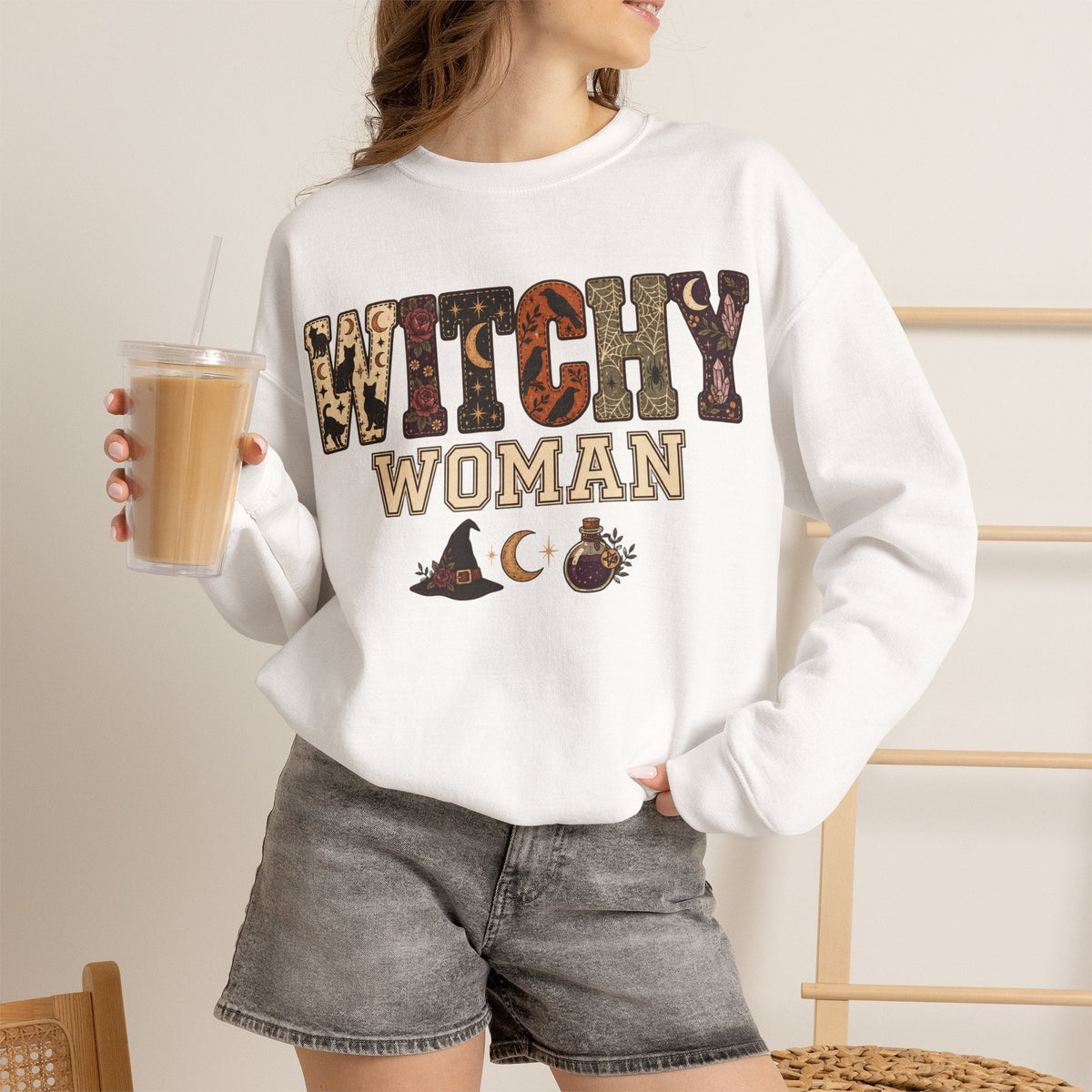 Wicked Thread Society white crewneck sweatshirt with Witchy Woman graphic print, worn with gray denim shorts.