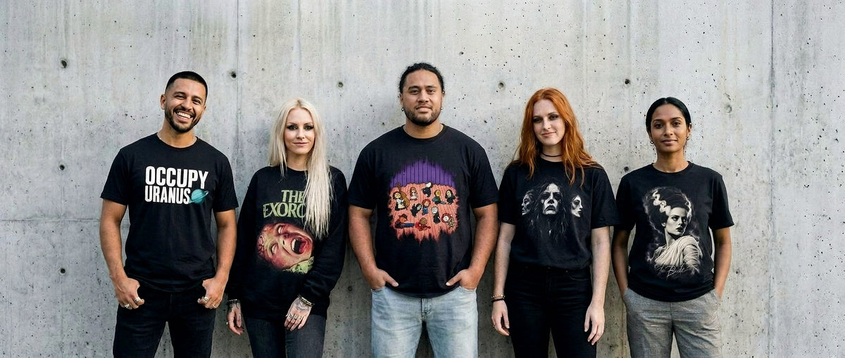Five friends wearing Wicked Thread Society tees and sweatshirts against a cement wall